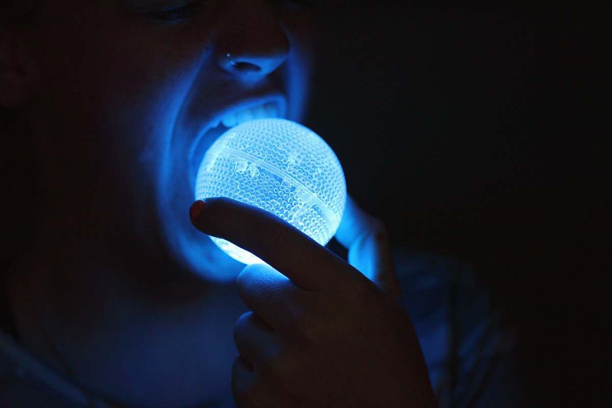 ogden person about to eat blue LED light ball blue